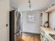 Kitchen area featuring stainless steel refrigerator, window and functional design elements at 1335 S Sherman St, Denver, CO 80210