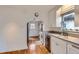 A well-lit kitchen featuring hardwood floors, white cabinetry and stainless steel appliances at 1335 S Sherman St, Denver, CO 80210