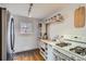 A functional kitchen with stainless steel fridge and gas range featuring practical shelving at 1335 S Sherman St, Denver, CO 80210