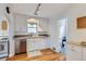 Bright kitchen showcasing stainless steel appliances, white cabinets and hardwood floors at 1335 S Sherman St, Denver, CO 80210