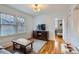 Inviting living room with hardwood floors, large windows, and a view to the adjacent bedroom at 1335 S Sherman St, Denver, CO 80210