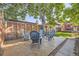 Cozy backyard patio with comfortable seating, mature trees, privacy fencing, and ample shade for outdoor enjoyment at 1335 S Sherman St, Denver, CO 80210