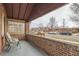 Inviting front porch with brick surround, providing a cozy outdoor seating area with neighborhood views at 1335 S Sherman St, Denver, CO 80210