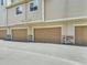 Attached garage with a brown door and stone accents at 11250 Florence St # 29D, Commerce City, CO 80640