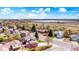 Aerial view showcasing the neighborhood and a serene lake in the distance at 140 Lane Ct, Fort Lupton, CO 80621