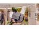 Aerial view of the fenced backyard with a trampoline and mature trees at 140 Lane Ct, Fort Lupton, CO 80621