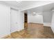 Finished basement offering tile flooring and storage shelving at 140 Lane Ct, Fort Lupton, CO 80621