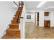Basement staircase leading into a finished room with tiled flooring and built-in storage cabinets at 140 Lane Ct, Fort Lupton, CO 80621