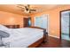 Primary bedroom with ensuite bathroom, closet, and hardwood flooring at 140 Lane Ct, Fort Lupton, CO 80621