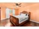 Bedroom with ceiling fan, a large window and hardwood flooring at 140 Lane Ct, Fort Lupton, CO 80621