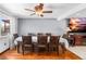 Formal dining room featuring hardwood floors and a charming ceiling fan fixture, creating a cozy and inviting atmosphere at 140 Lane Ct, Fort Lupton, CO 80621