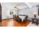 Bright dining area with hardwood floors, a ceiling fan, and ample space for entertaining, making every meal special at 140 Lane Ct, Fort Lupton, CO 80621
