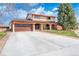 Charming two-story home with a wide driveway and landscaped front yard at 140 Lane Ct, Fort Lupton, CO 80621