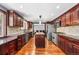 Spacious kitchen featuring custom cabinets, granite countertops, stainless steel appliances, and hardwood floors, ideal for cooking at 140 Lane Ct, Fort Lupton, CO 80621