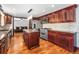 Well-appointed kitchen with stylish cabinetry, stainless steel appliances, a granite island, and hardwood floors, creating a modern aesthetic at 140 Lane Ct, Fort Lupton, CO 80621