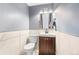 Stylish powder room with tiled walls, a new toilet and dark wood vanity at 140 Lane Ct, Fort Lupton, CO 80621
