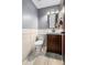 Modern powder room features tiled walls, a new toilet and dark wood vanity at 140 Lane Ct, Fort Lupton, CO 80621