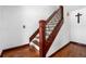 Wooden staircase with ornamental ironwork in the railing, connecting floors within the house at 140 Lane Ct, Fort Lupton, CO 80621