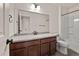 Bathroom with granite vanity and shower/tub combo with bronze fixtures at 4343 S Nepal Ct, Centennial, CO 80015