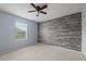 Bedroom with accent wall and ceiling fan; large window lets in natural light at 4343 S Nepal Ct, Centennial, CO 80015