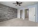 Bedroom with accent wall, ceiling fan, closet and view to hallway at 4343 S Nepal Ct, Centennial, CO 80015