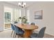 Cozy dining room featuring a modern table, stylish chairs, and natural light from sliding glass doors at 4343 S Nepal Ct, Centennial, CO 80015