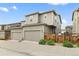 Exterior view of home featuring two car garage and side yard with wooden fence at 4343 S Nepal Ct, Centennial, CO 80015