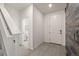 Neutral foyer showcasing tile flooring, a staircase, and a view into a nearby powder room at 4343 S Nepal Ct, Centennial, CO 80015