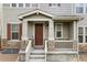 Inviting front porch features stone accents, a covered entryway, and a charming white railing at 4343 S Nepal Ct, Centennial, CO 80015