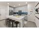Bright and airy kitchen with quartz countertops, stainless steel appliances, and island with bar seating at 4343 S Nepal Ct, Centennial, CO 80015