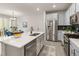 Open kitchen with a large island, stainless steel appliances, and adjacent dining area at 4343 S Nepal Ct, Centennial, CO 80015