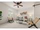 Bright living room with neutral decor, stylish seating, and a modern ceiling fan at 4343 S Nepal Ct, Centennial, CO 80015
