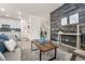 Inviting living room with stylish wood accent wall, modern furniture, and open floor plan at 4343 S Nepal Ct, Centennial, CO 80015