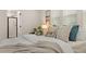 Closeup of a bed with pillows, a blanket, and a view into the bathroom at 4343 S Nepal Ct, Centennial, CO 80015