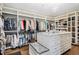 Custom walk-in closet with island, shelving, and ample storage space at 9042 E Vassar Ave, Denver, CO 80231