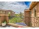 A cozy outdoor balcony with ornamental railing overlooking a manicured green space at 9218 Viaggio Way, Highlands Ranch, CO 80126