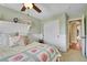 Bedroom featuring a bed with a floral quilt and access to an en-suite bathroom at 9218 Viaggio Way, Highlands Ranch, CO 80126