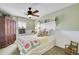 Cozy bedroom featuring a ceiling fan and window with views of nature at 9218 Viaggio Way, Highlands Ranch, CO 80126