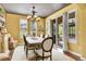Well-lit dining room featuring a dining table, an elegant chandelier, and a sliding glass door leading to the patio at 9218 Viaggio Way, Highlands Ranch, CO 80126