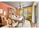 Bright dining room with a large table, stylish chandelier, and ample natural light from the windows at 9218 Viaggio Way, Highlands Ranch, CO 80126
