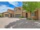 Exterior showcasing garages, brick driveway and manicured front yard at 9218 Viaggio Way, Highlands Ranch, CO 80126