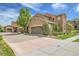 Attractive home exterior with a paver driveway, manicured landscaping, and an attached garage at 9218 Viaggio Way, Highlands Ranch, CO 80126