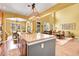 Open concept kitchen with a large island, granite countertops, and an attached breakfast nook and living space at 9218 Viaggio Way, Highlands Ranch, CO 80126