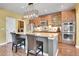 Gourmet kitchen with granite countertops, stainless steel appliances, a breakfast bar, and custom cabinetry at 9218 Viaggio Way, Highlands Ranch, CO 80126
