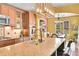Modern kitchen featuring stainless steel appliances, granite countertops, and a stylish light fixture at 9218 Viaggio Way, Highlands Ranch, CO 80126