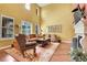 Spacious living room with large windows, hardwood floors, a fireplace, and ample seating arrangement at 9218 Viaggio Way, Highlands Ranch, CO 80126