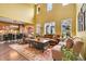 Bright living room with high ceilings, plantation shutters, and hardwood floors offers a comfortable and inviting space at 9218 Viaggio Way, Highlands Ranch, CO 80126