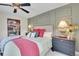 Comfortable bedroom with stylish wall accents, a plush bed, and a decorative lamp on the nightstand at 9218 Viaggio Way, Highlands Ranch, CO 80126