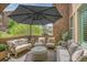 Inviting outdoor patio with comfortable seating and shade from a large umbrella at 9218 Viaggio Way, Highlands Ranch, CO 80126