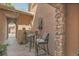 Private patio features sleek brick floors, a stone wall fountain, and elegant outdoor furniture for relaxing at 9218 Viaggio Way, Highlands Ranch, CO 80126